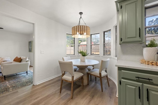 dining room featuring a notable chandelier and light wood-type flooring