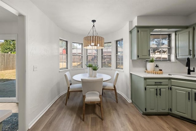 dining space featuring light hardwood / wood-style floors and sink