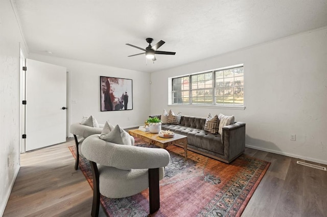 living room with hardwood / wood-style floors and ceiling fan