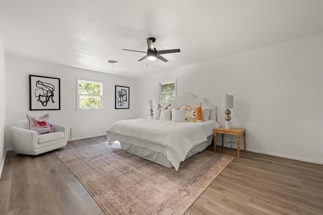 bedroom with ceiling fan and hardwood / wood-style flooring