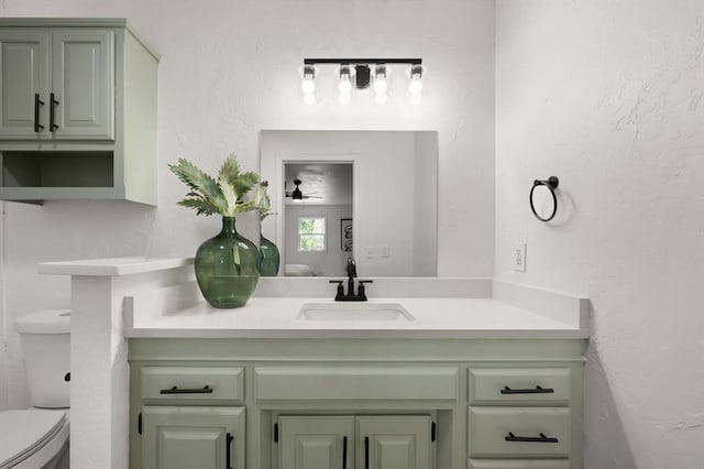 bathroom featuring ceiling fan, vanity, and toilet