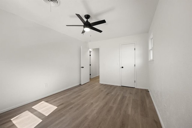 unfurnished bedroom with ceiling fan and wood-type flooring