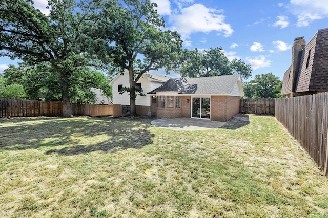 rear view of property with a patio area and a yard