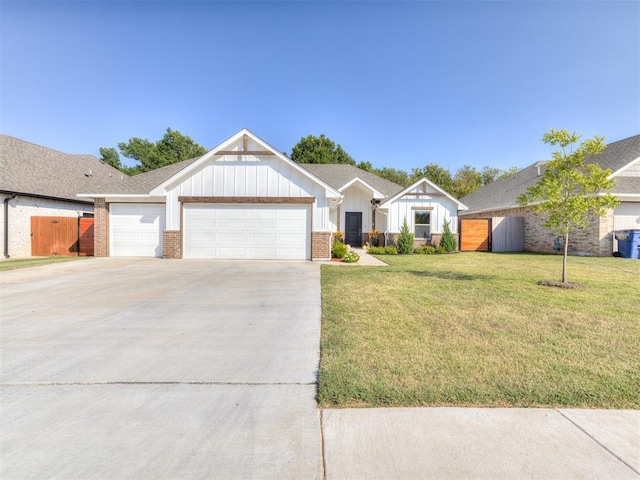 ranch-style home featuring a front lawn and a garage