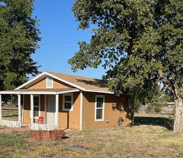 view of home's exterior featuring a yard and covered porch