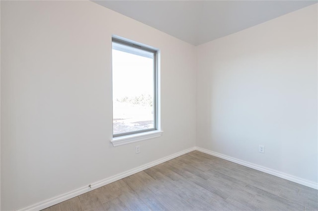 empty room featuring wood finished floors and baseboards