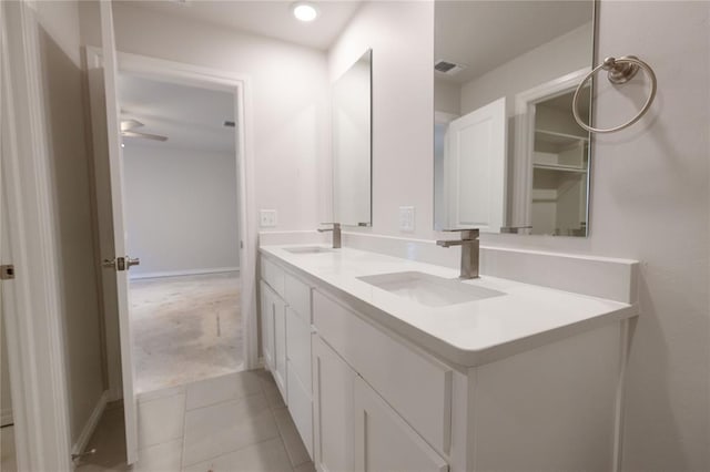 bathroom with double vanity, a sink, visible vents, and tile patterned floors