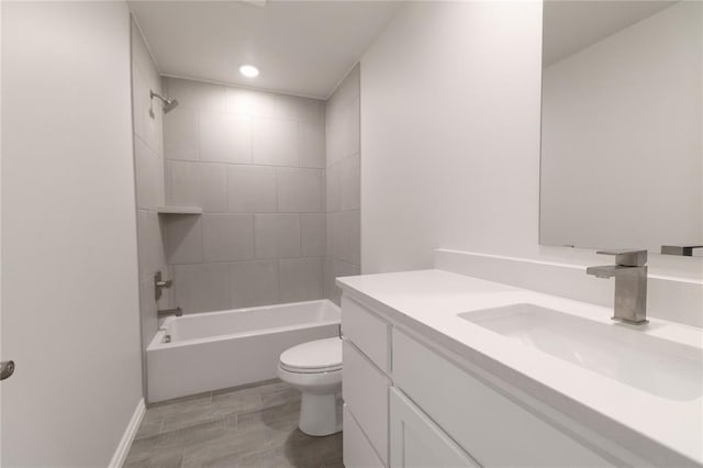 bathroom with bathing tub / shower combination, vanity, and toilet