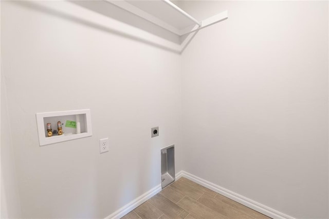 laundry room with laundry area, baseboards, hookup for a washing machine, wood tiled floor, and electric dryer hookup