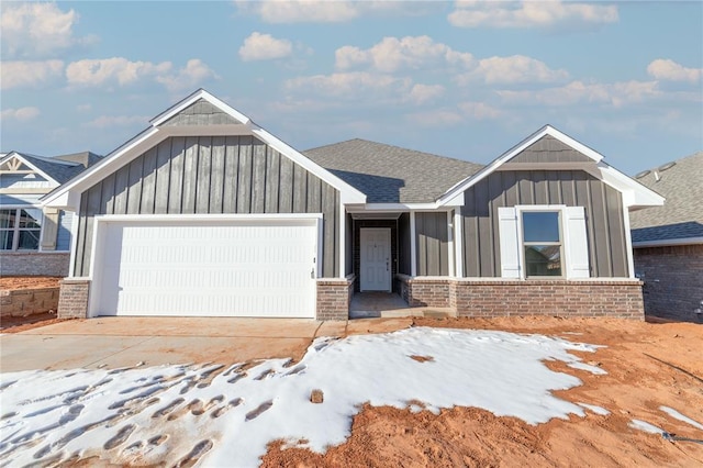 view of front of home featuring driveway, brick siding, board and batten siding, and an attached garage