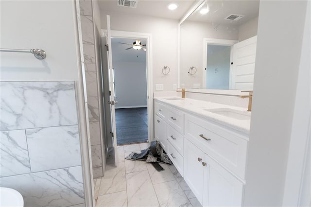 full bathroom featuring marble finish floor, double vanity, a sink, and visible vents