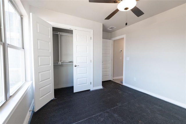 unfurnished bedroom with ceiling fan, a closet, visible vents, and baseboards