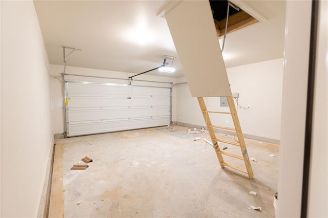 garage with a garage door opener and baseboards