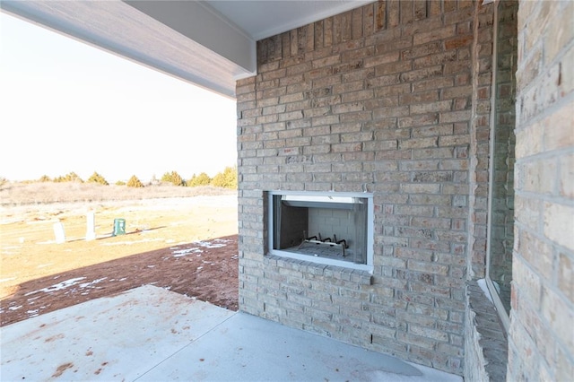 view of patio with an outdoor brick fireplace