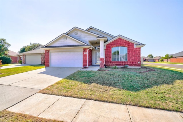 view of front of property featuring a front yard and a garage