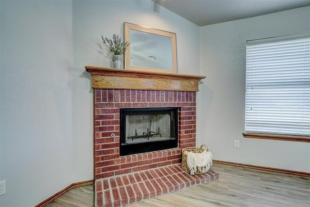 room details with hardwood / wood-style floors and a brick fireplace