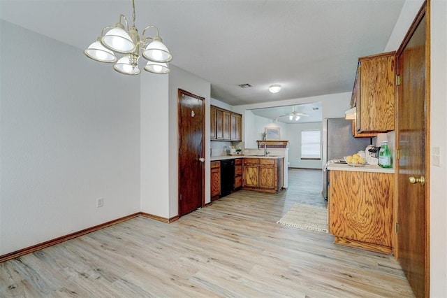 kitchen with dishwasher, ceiling fan with notable chandelier, stainless steel refrigerator, and light hardwood / wood-style flooring