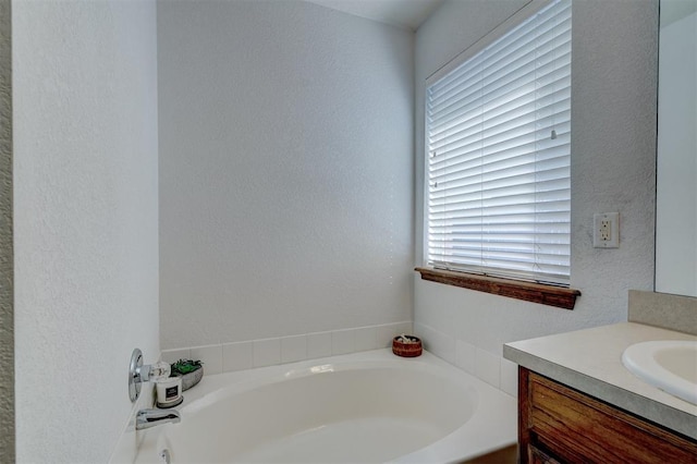 bathroom with vanity and a tub to relax in