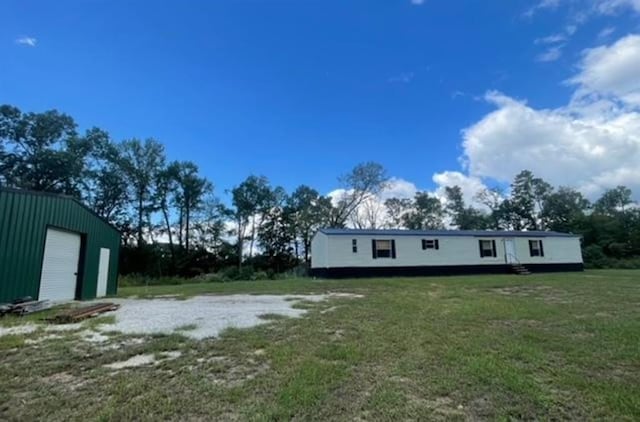 view of yard featuring an outbuilding and a garage