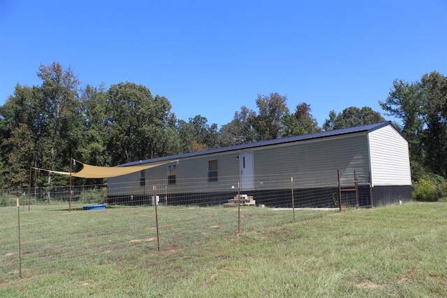 rear view of house with a yard