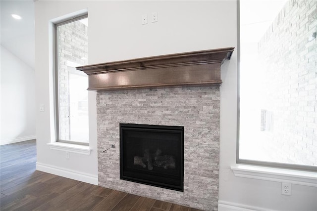 9312 Poppey Pl, Yukon, OK 73099 - detailed view of wood finished floors, a glass covered fireplace, and baseboards