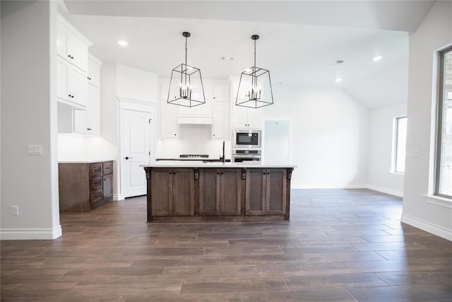 9312 Poppey Pl, Yukon, OK 73099 - kitchen featuring white cabinets, built in microwave, light countertops, dark wood-style flooring, and a kitchen island with sink