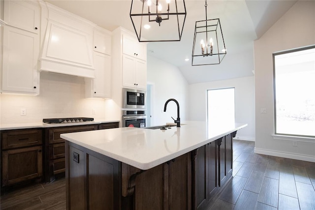 9312 Poppey Pl, Yukon, OK 73099 - kitchen featuring stainless steel oven, a chandelier, lofted ceiling, a sink, and built in microwave