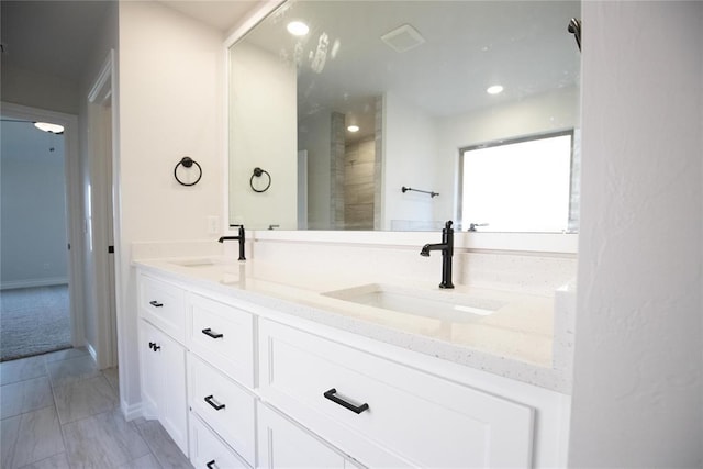 9312 Poppey Pl, Yukon, OK 73099 - bathroom featuring double vanity, recessed lighting, and baseboards