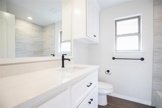 9312 Poppey Pl, Yukon, OK 73099 - bathroom featuring a shower, toilet, wood finished floors, vanity, and baseboards
