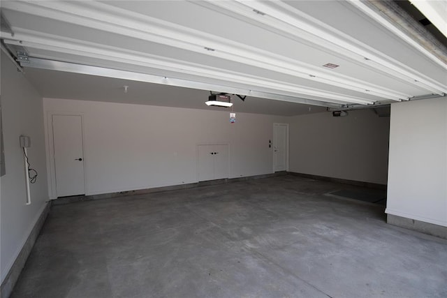 9312 Poppey Pl, Yukon, OK 73099 - garage featuring a garage door opener and baseboards