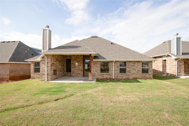 9312 Poppey Pl, Yukon, OK 73099 - back of house with a patio, a shingled roof, a chimney, brick siding, and a lawn