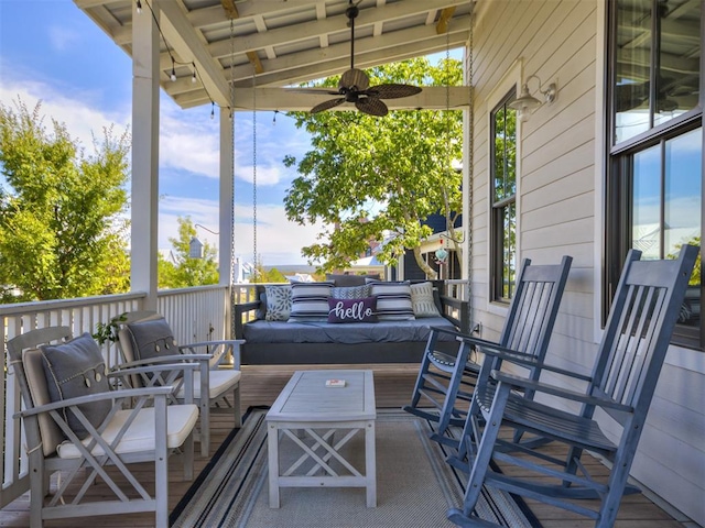 view of patio with an outdoor living space and ceiling fan