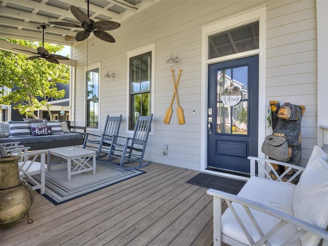 wooden deck featuring a porch, an outdoor hangout area, and ceiling fan