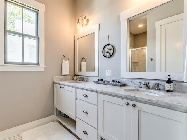 bathroom with tile patterned floors, vanity, and walk in shower