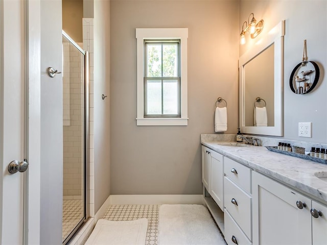 bathroom with vanity and a shower with shower door