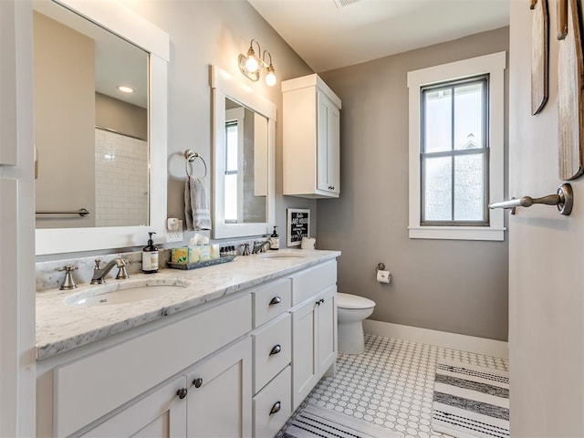 bathroom featuring tile patterned floors, vanity, toilet, and walk in shower