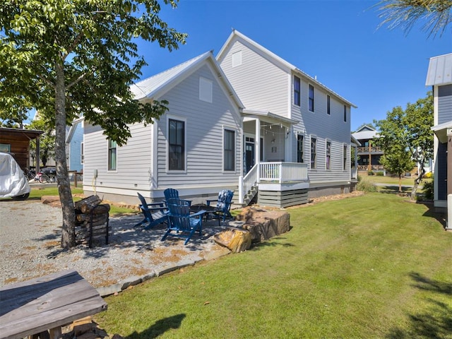 rear view of property with a lawn