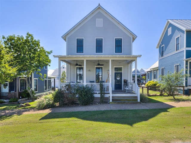 view of front of property with ceiling fan, covered porch, and a front yard