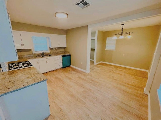 kitchen with sink, black dishwasher, light hardwood / wood-style flooring, decorative light fixtures, and white cabinets