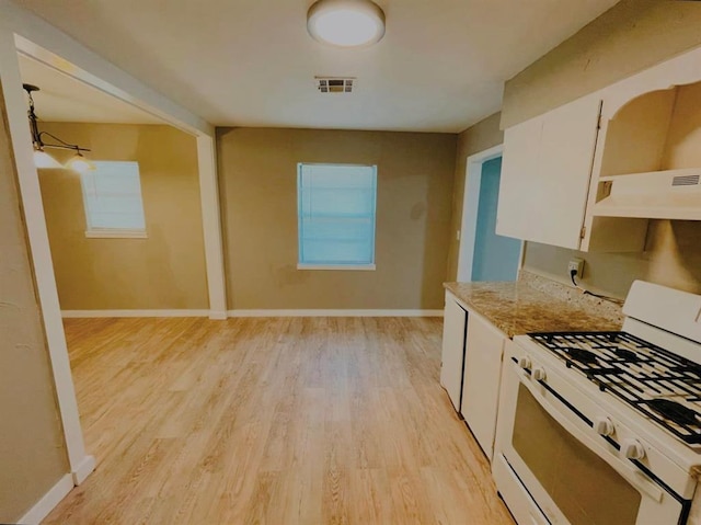 kitchen with white cabinets, light hardwood / wood-style floors, ventilation hood, and white gas range oven