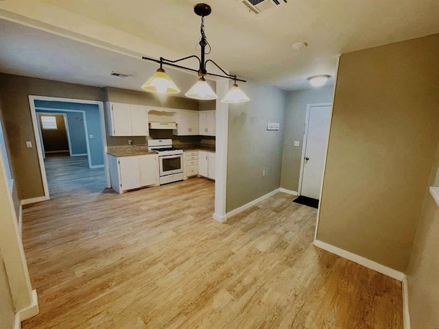 kitchen with light wood-type flooring, white gas range oven, pendant lighting, a notable chandelier, and white cabinetry