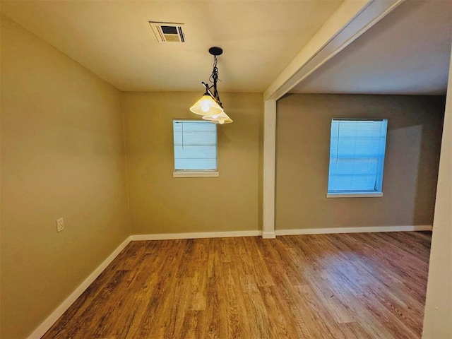 unfurnished dining area featuring wood-type flooring