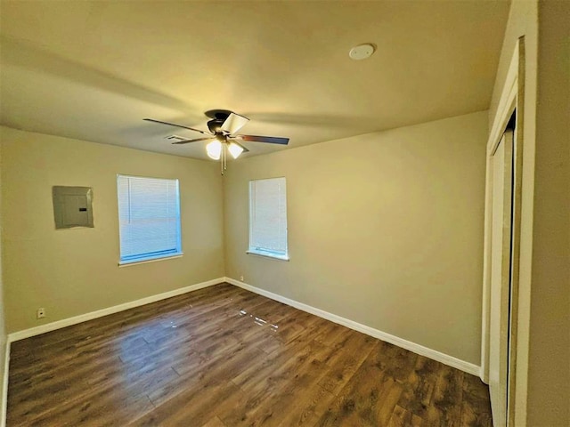 interior space featuring electric panel, ceiling fan, and dark wood-type flooring