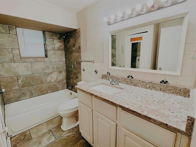 full bathroom featuring vanity, toilet, tiled shower / bath, and tasteful backsplash