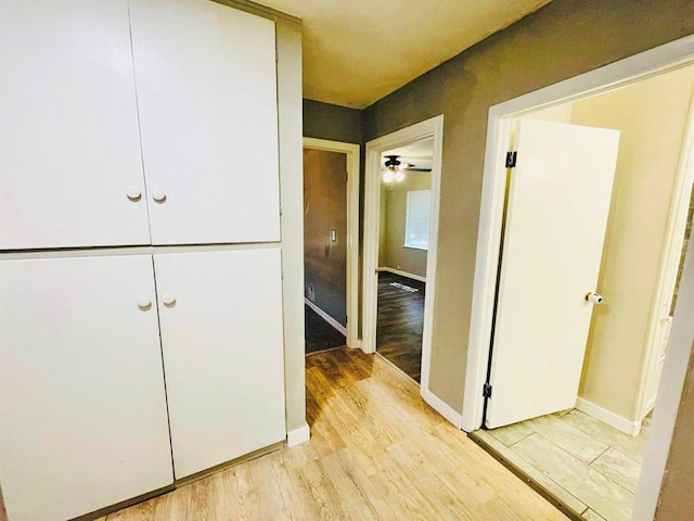 hallway with light hardwood / wood-style flooring