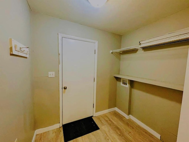 laundry area with hookup for a washing machine and light wood-type flooring