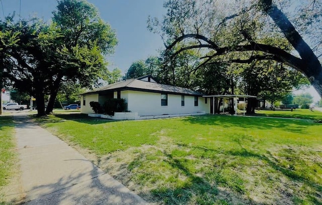 view of side of property with a lawn