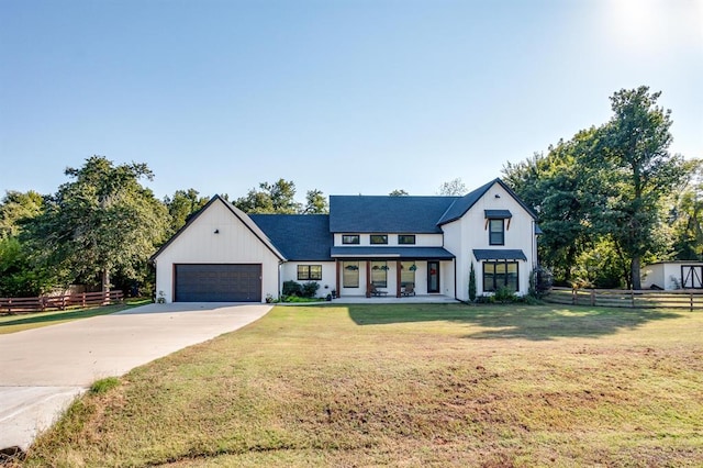 view of front of house featuring a garage and a front lawn