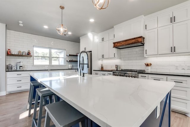 kitchen featuring backsplash, a large island, and decorative light fixtures