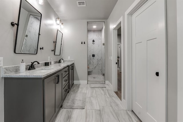 bathroom with a shower with door and vanity